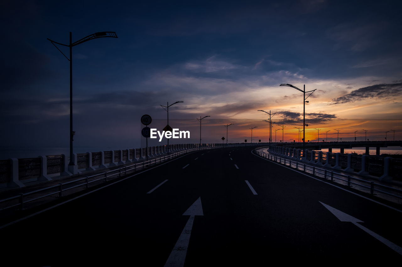 ROAD AGAINST SKY DURING SUNSET