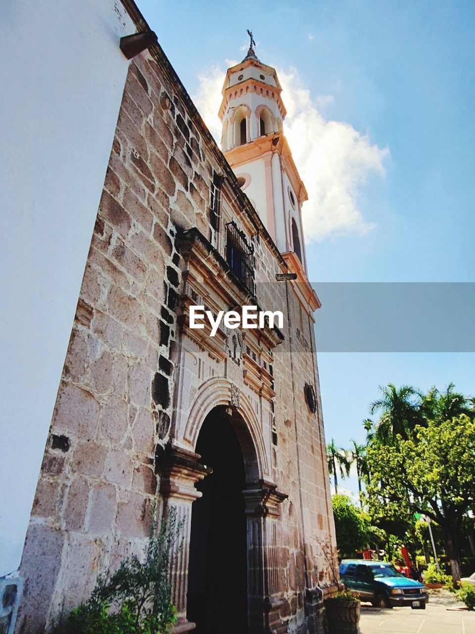 architecture, built structure, building exterior, sky, travel destinations, history, landmark, religion, the past, place of worship, building, nature, tower, travel, belief, city, tree, plant, town, tourism, day, spirituality, arch, bell tower, low angle view, no people, sunny, blue, outdoors, car, clear sky, cloud, street, sunlight, vehicle, old, transportation