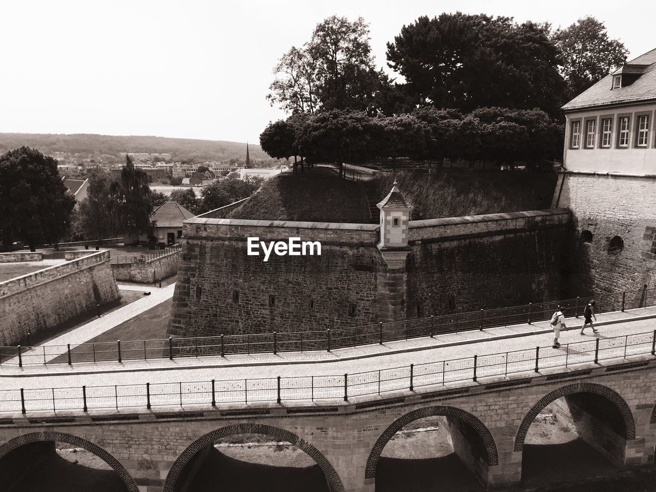 High angle view of old bridge by fortress against clear sky