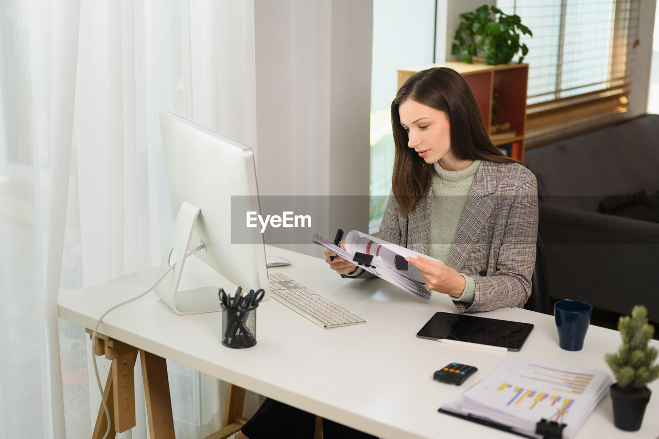 businesswoman working on table at home