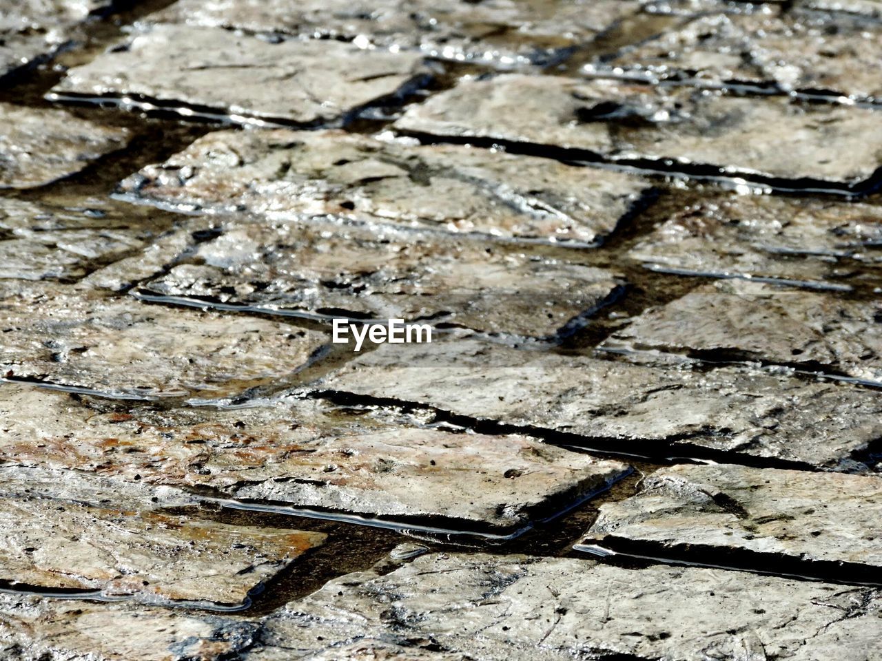 Full frame shot of wet cobblestone street