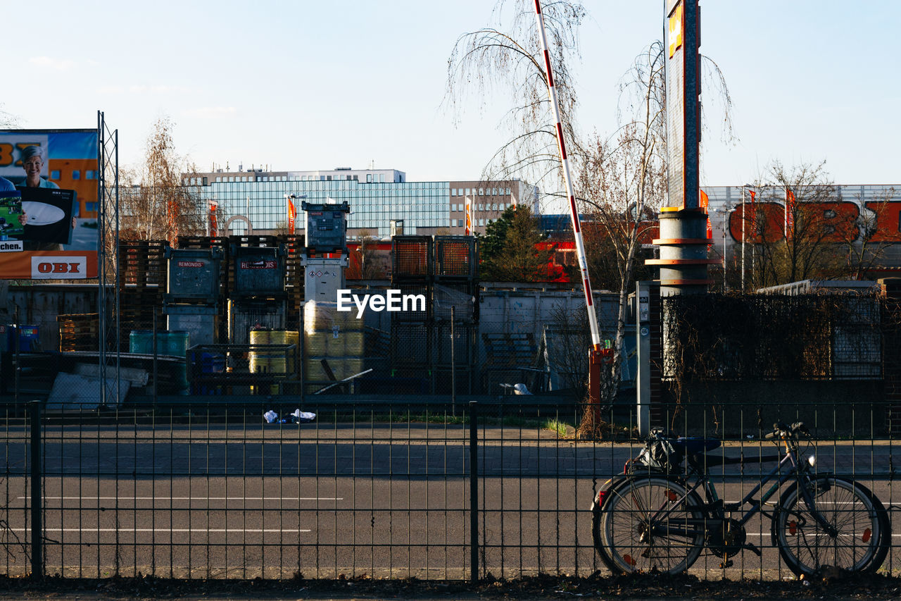 BICYCLES ON WET CITY AGAINST SKY