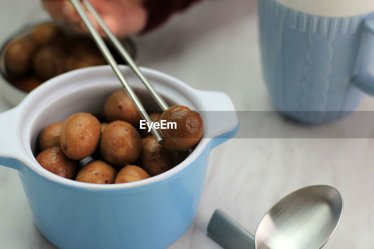 Pick brown quail egg semur telur puyuh with chopstick, banchan side dish in korean food