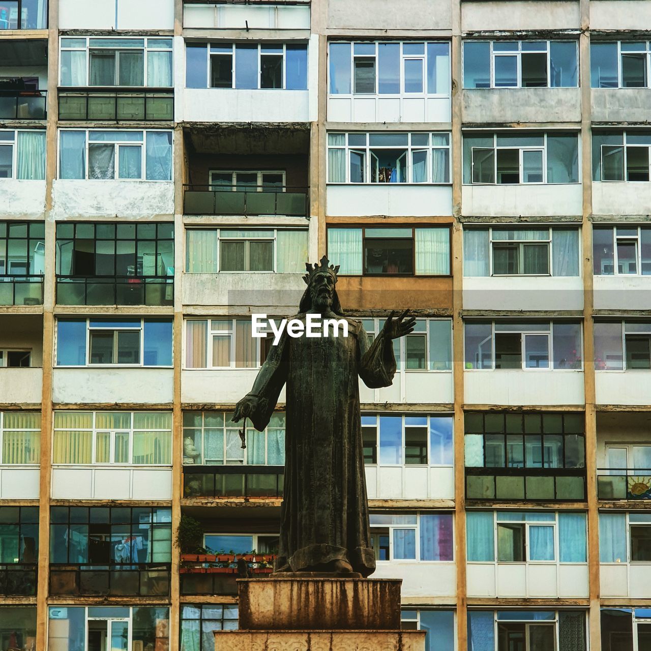 Low angle view of statue against building in city