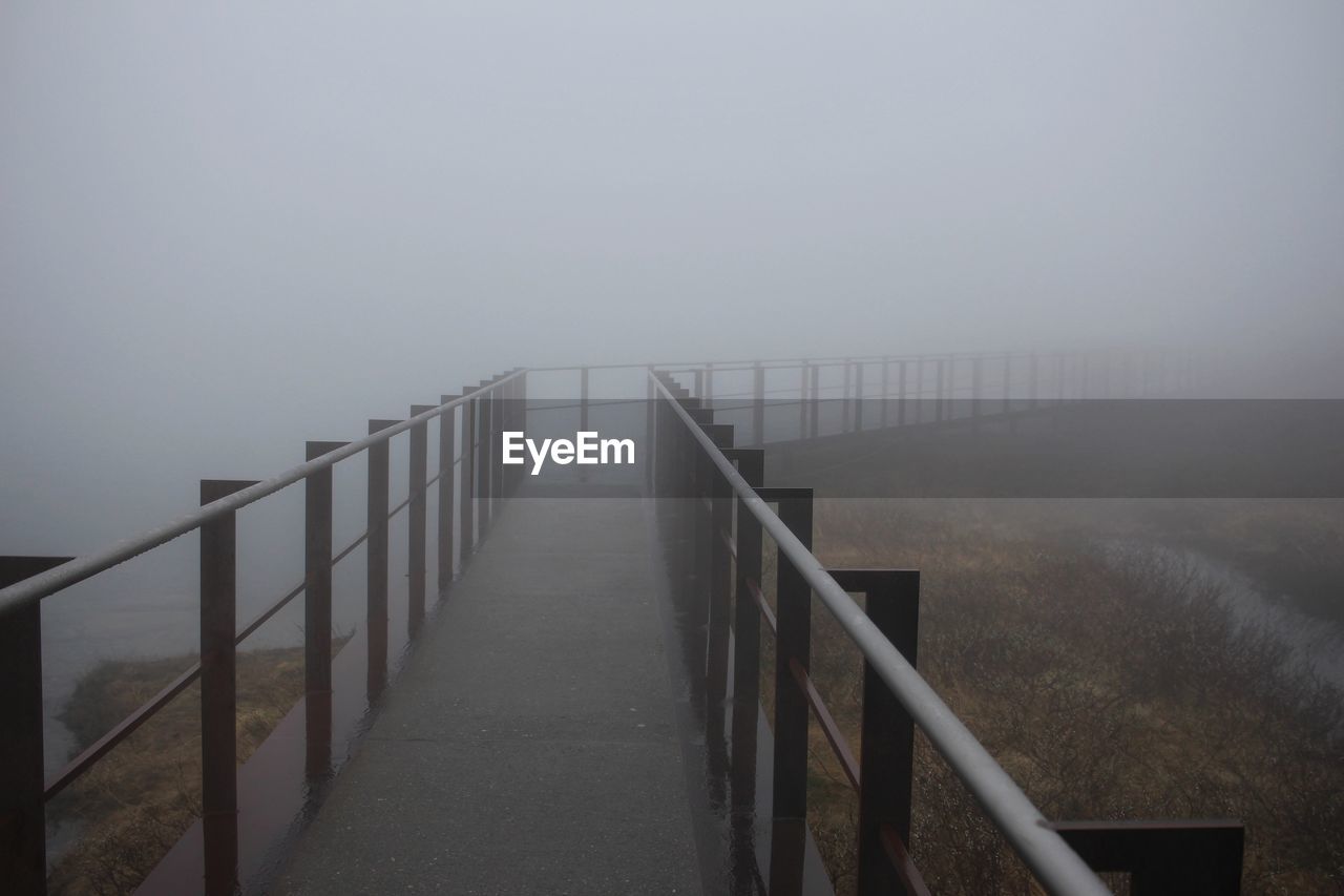 View of wooden walkway against sky