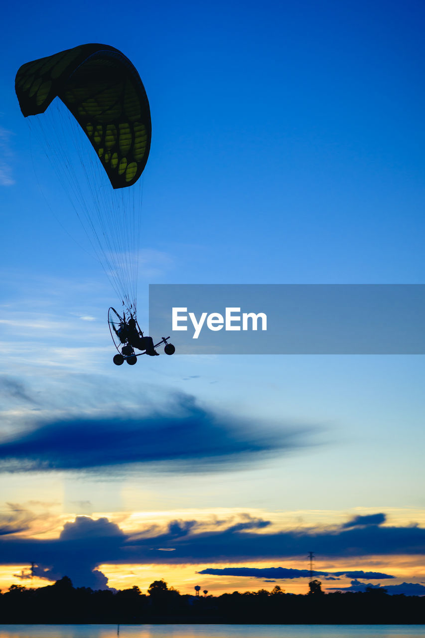 LOW ANGLE VIEW OF PERSON PARAGLIDING AGAINST SKY