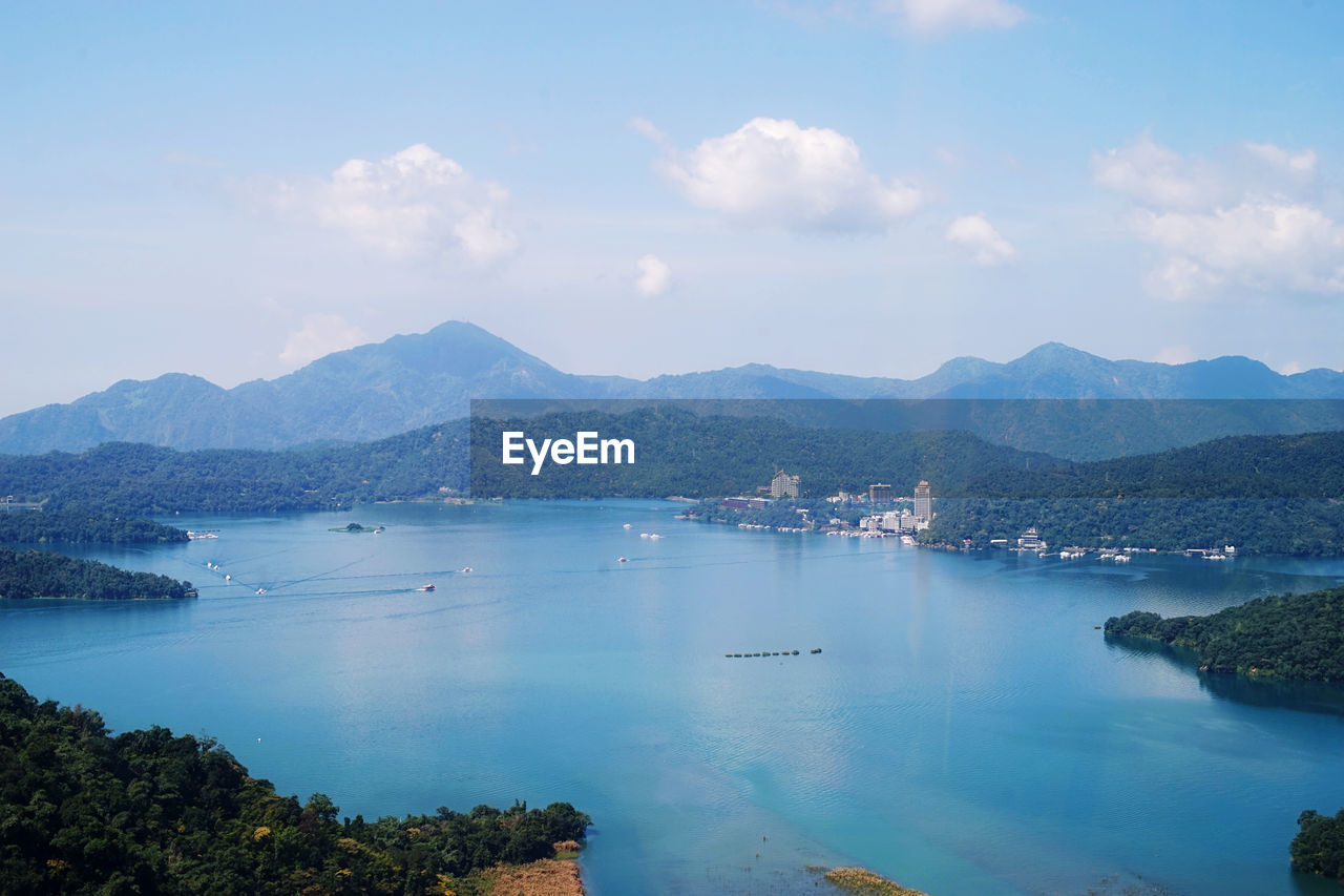 Scenic view of sea and mountains against sky