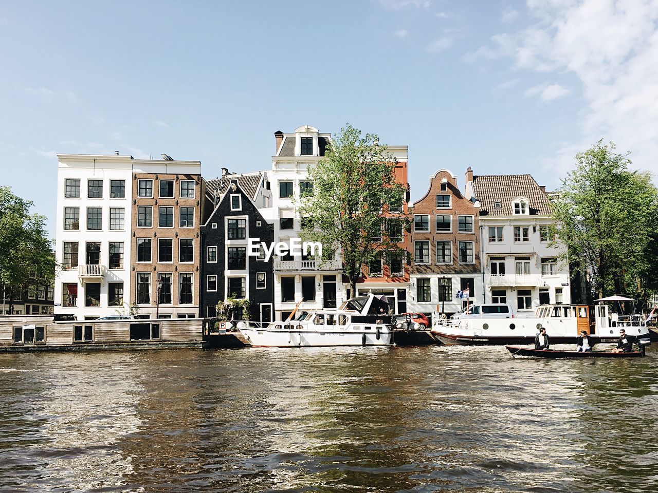 Boats in river with buildings in background