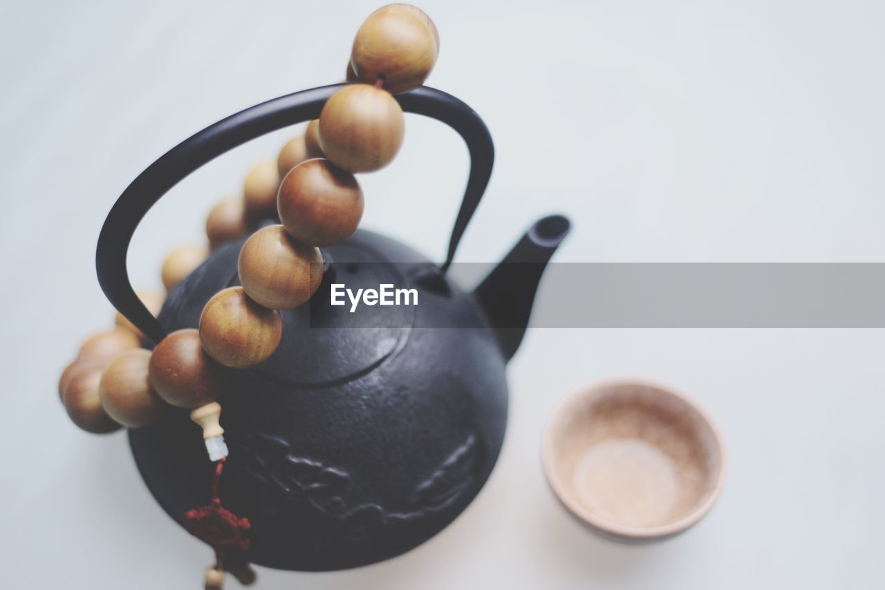 Close-up of beads on tea kettle