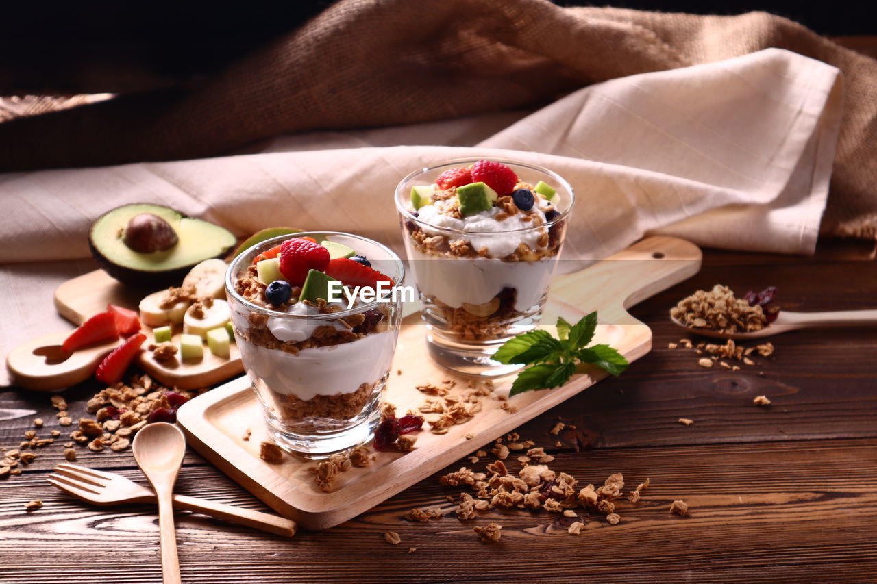 HIGH ANGLE VIEW OF ICE CREAM WITH FRUITS ON TABLE