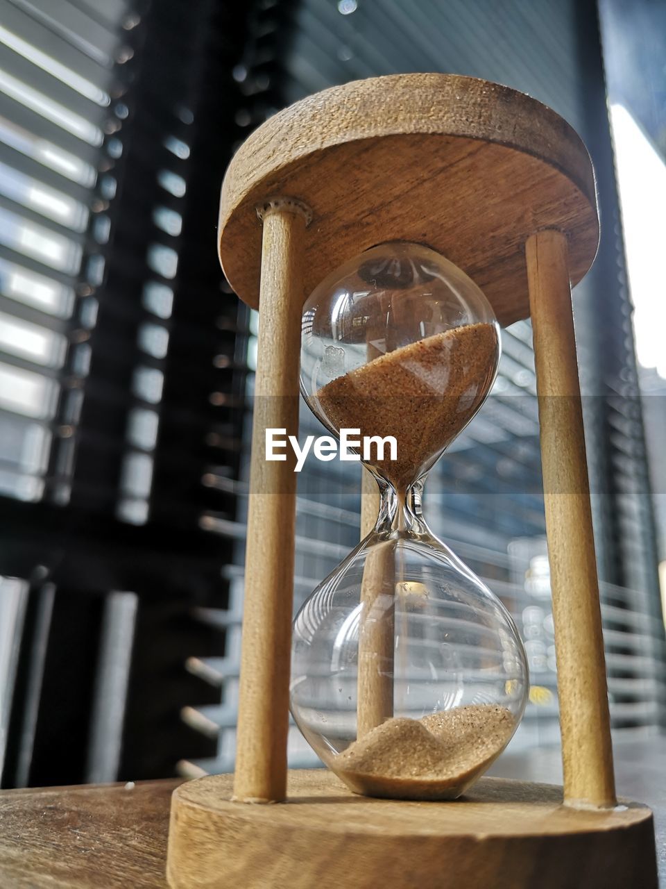 Low angle view of hourglass on table