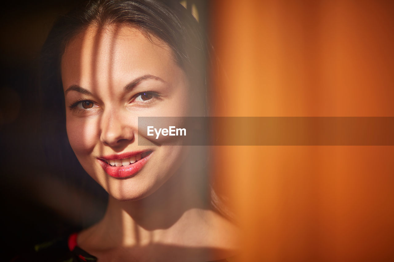 Close-up portrait of smiling mid adult woman