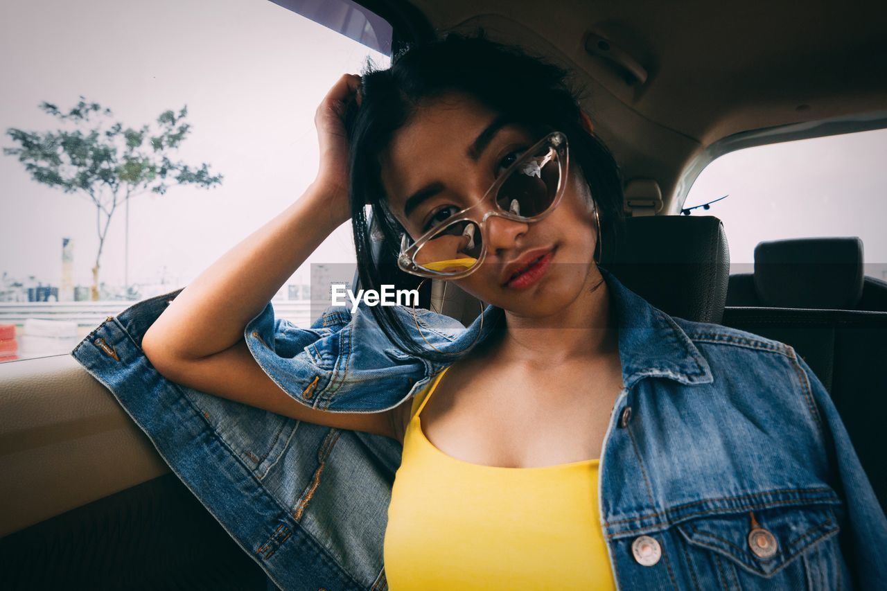 Portrait of young woman traveling in car