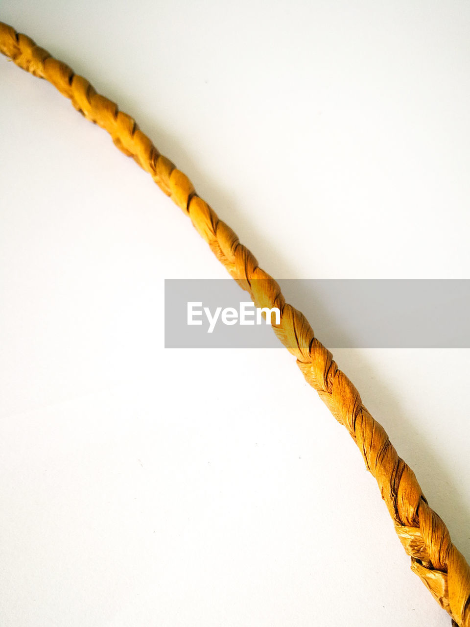 High angle view of yellow rope on white background
