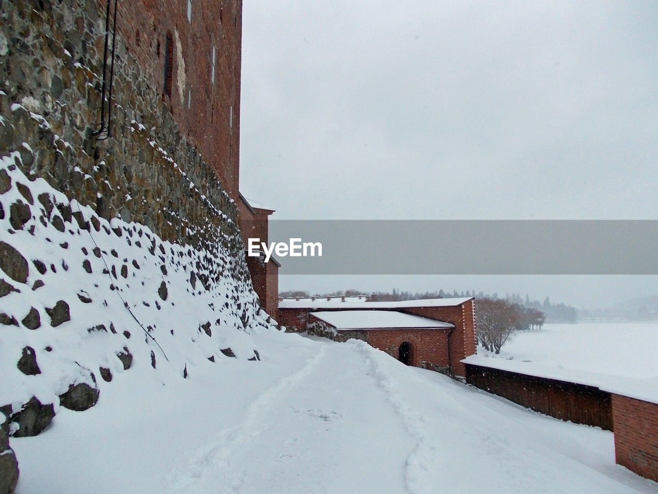 snow, winter, cold temperature, architecture, built structure, nature, building exterior, environment, freezing, building, day, no people, water, sky, scenics - nature, blizzard, beauty in nature, travel, wall, travel destinations, house, outdoors, landscape, frozen, white, snowing, storm, winter storm, extreme weather, tourism