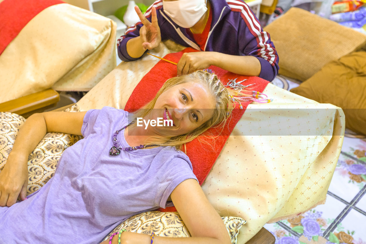 High angle portrait of woman resting at home