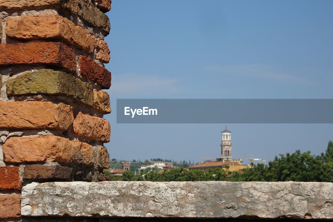 Stone wall of building against sky