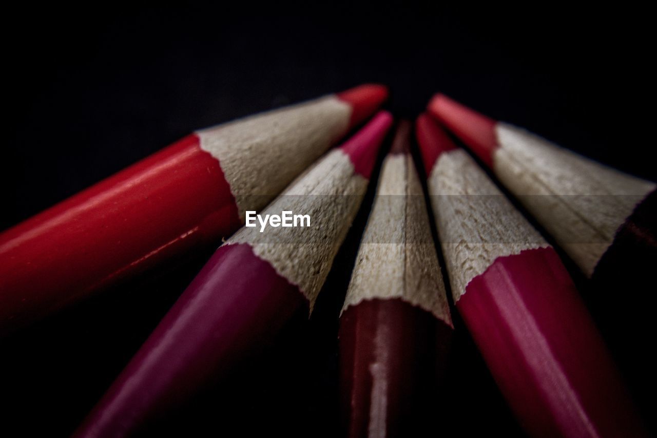 Close-up of colored pencils against black background