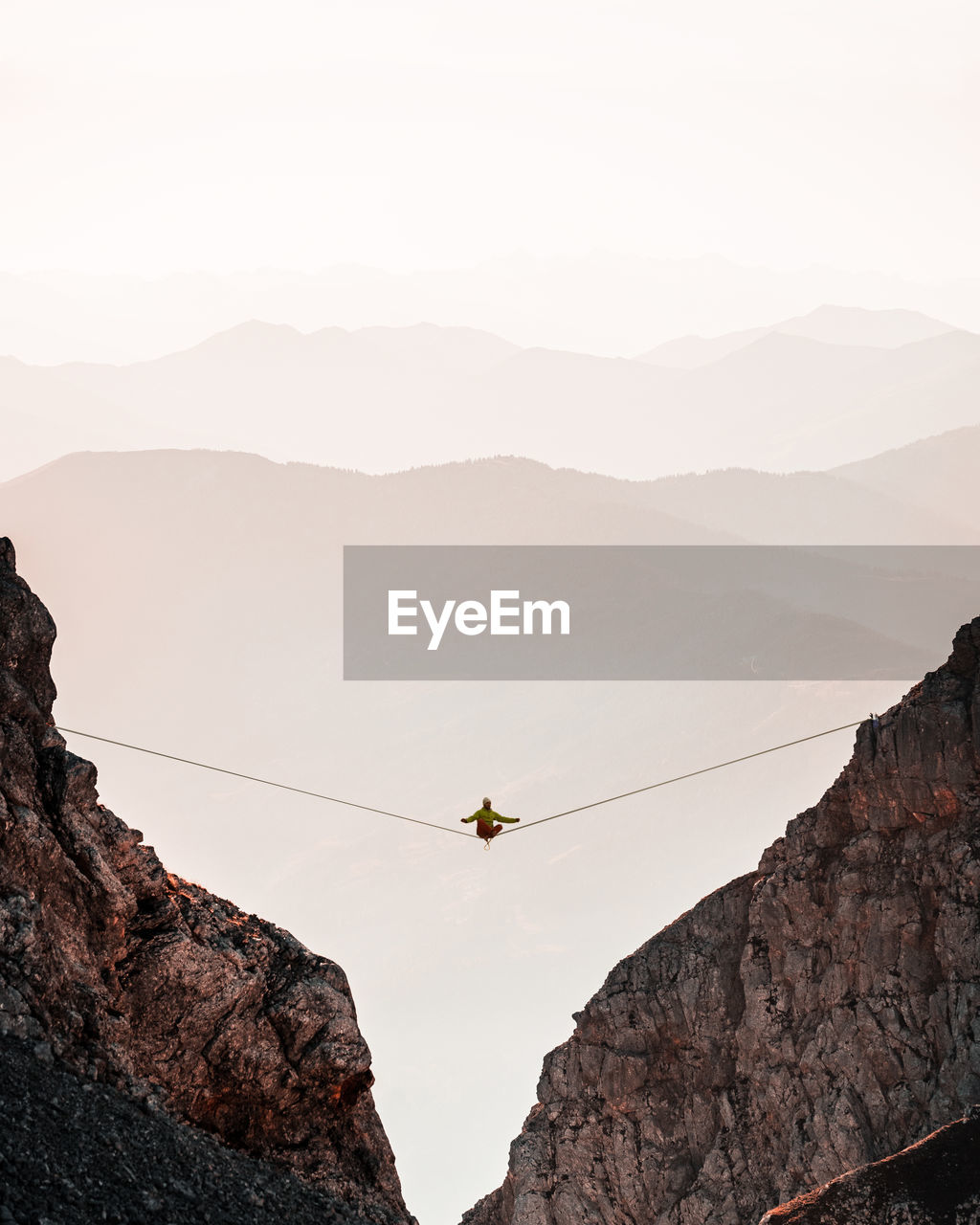 Low angle view of people on rock against sky