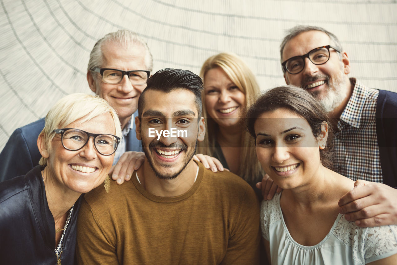 Team of confident business people smiling in office