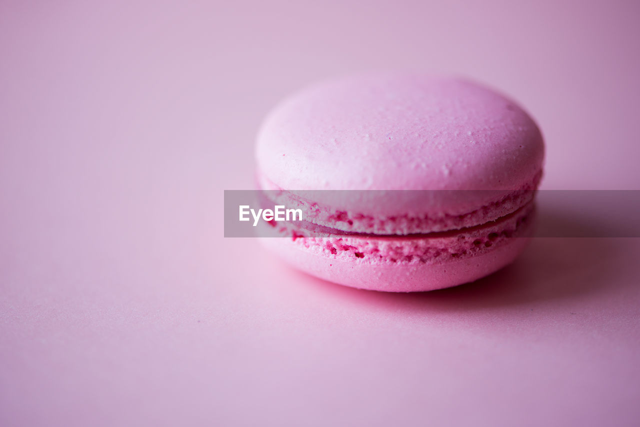 High angle view of macaroon on pink background