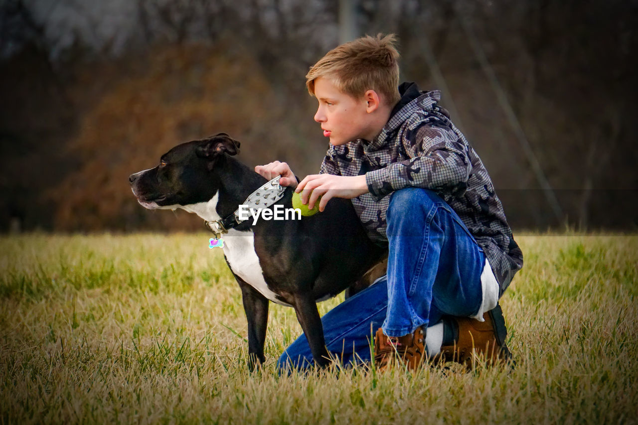 Portrait of young teenage boy and his dog