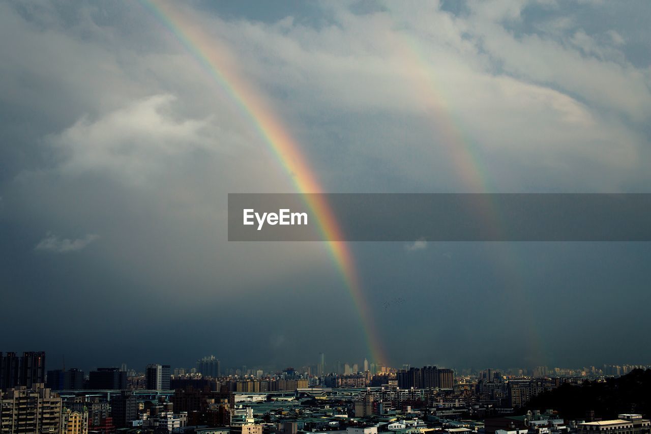 RAINBOW OVER CITYSCAPE