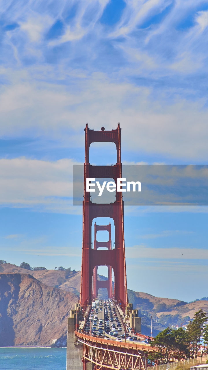 View of suspension bridge against cloudy sky