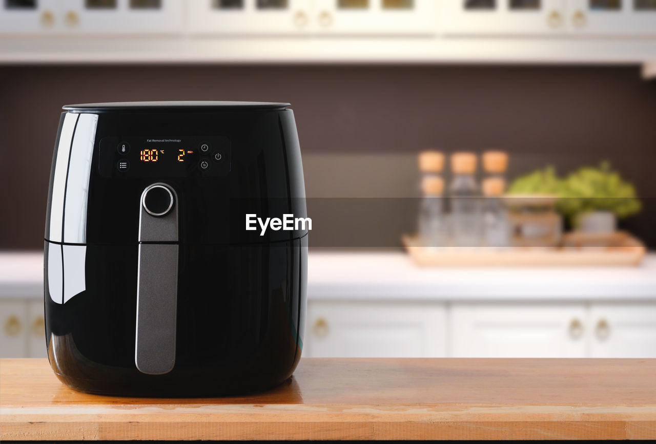 Air fryer machine cooking potato fried in kitchen. lifestyle of new normal cooking.