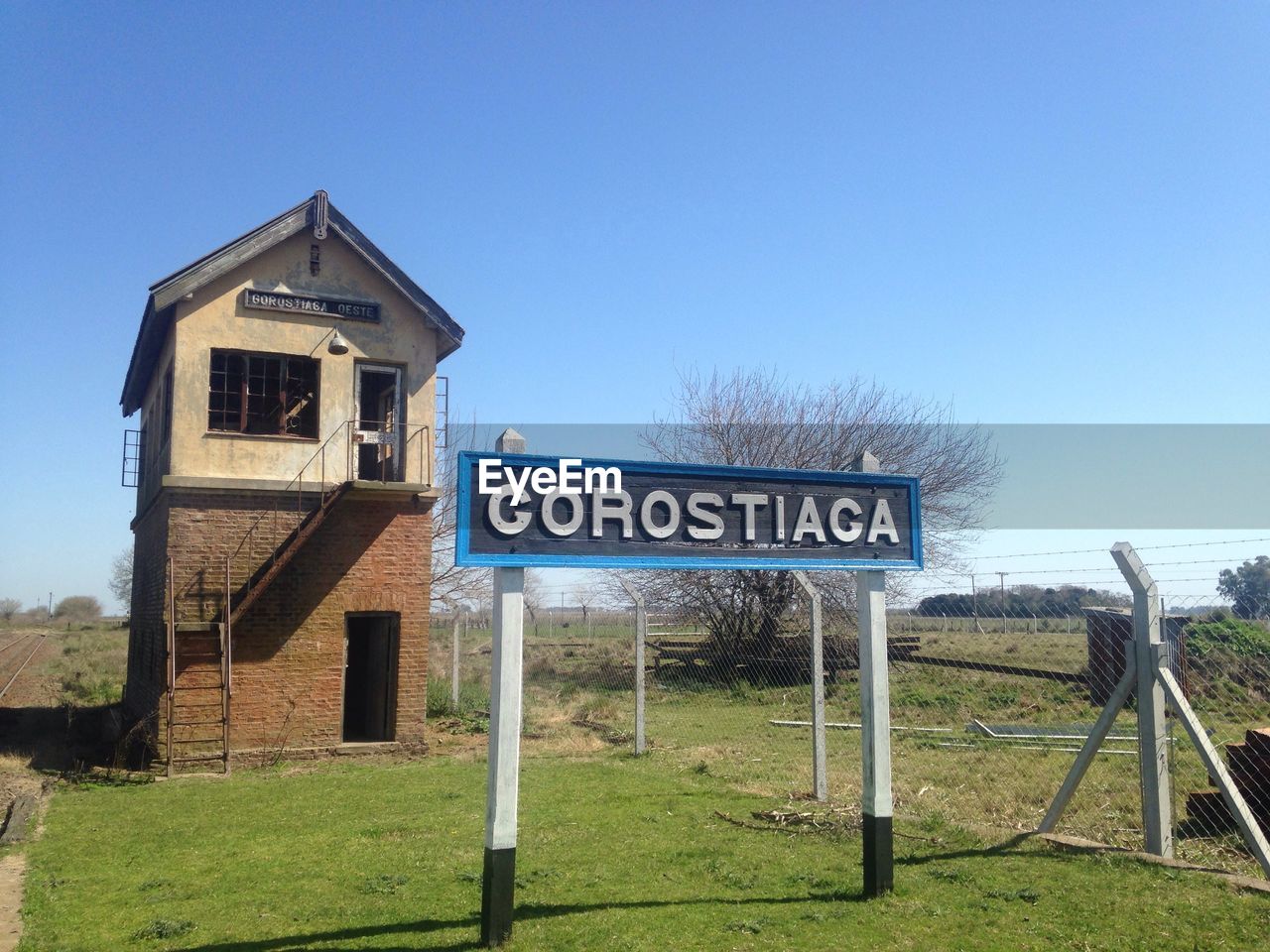 ROAD SIGN AGAINST CLEAR BLUE SKY