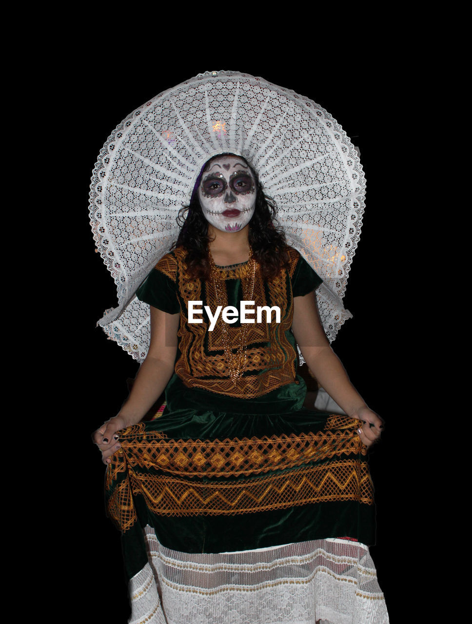 Portrait of woman wearing halloween costume against black background