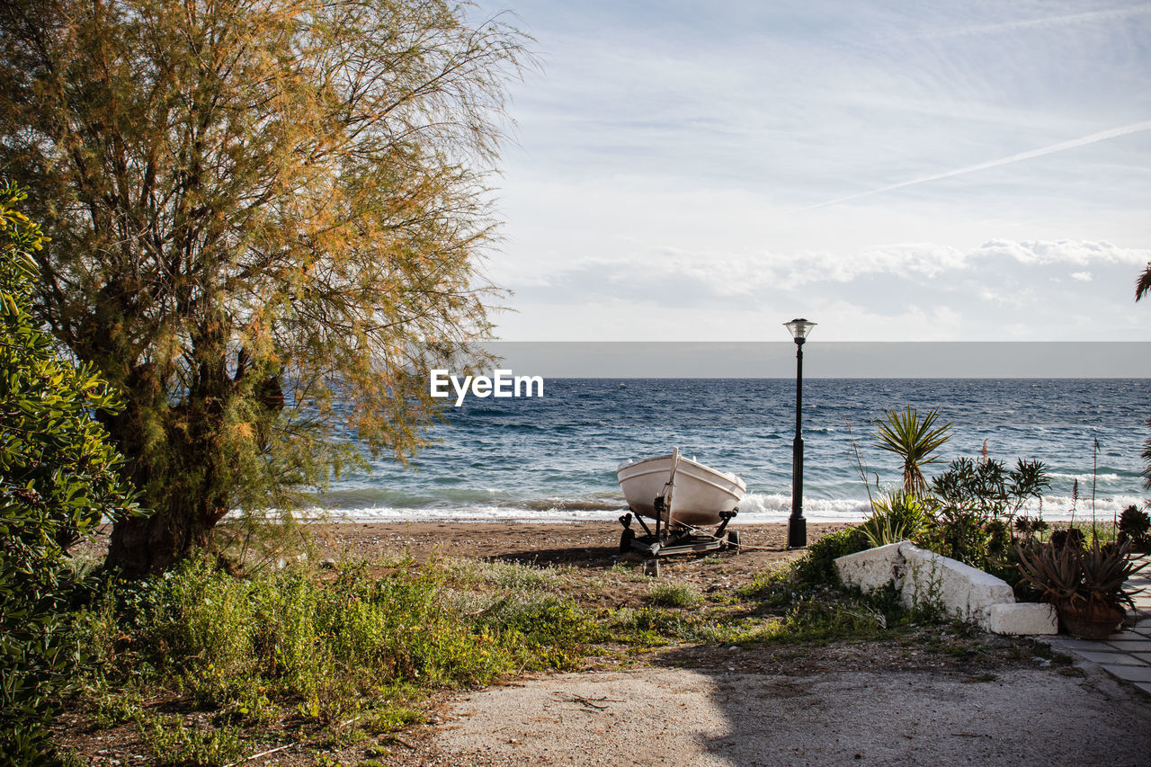 Tranquil scene with cloudy sky and sea with light waves