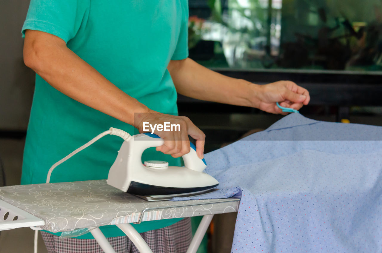 Midsection of man working on table