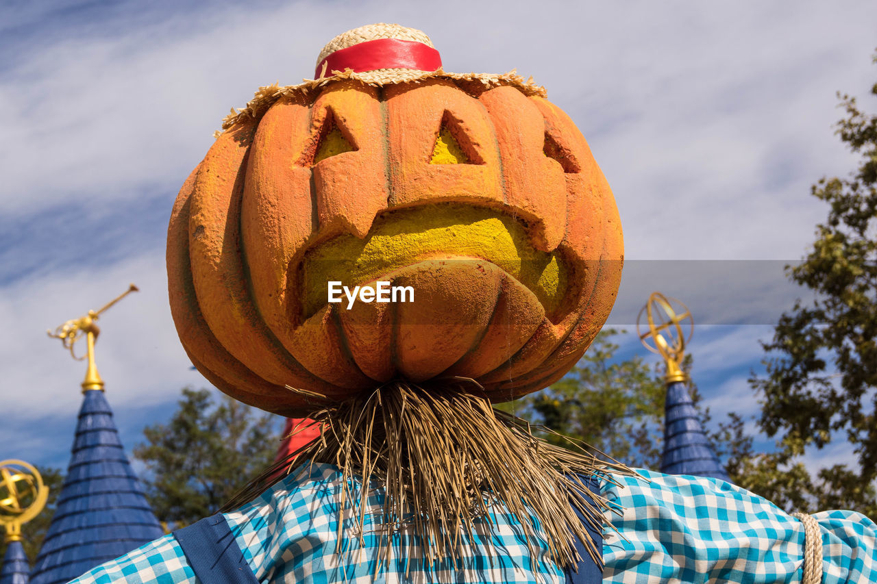 FULL FRAME SHOT OF PUMPKIN AND TREES AGAINST SKY DURING HALLOWEEN