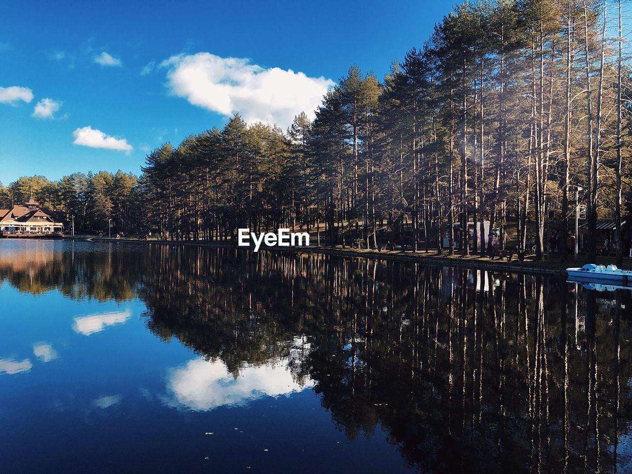 Reflection of trees in lake against sky