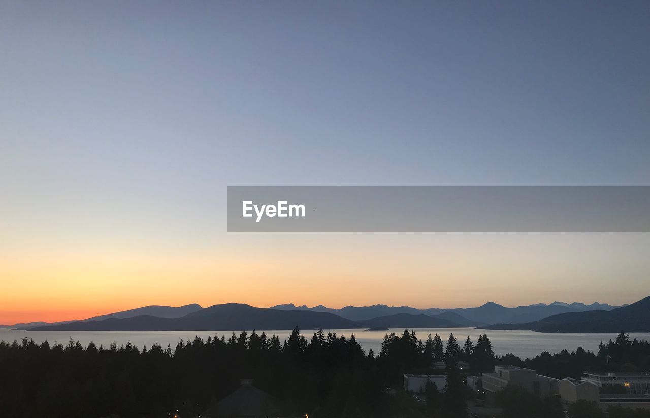 SILHOUETTE MOUNTAINS AGAINST CLEAR SKY DURING SUNSET