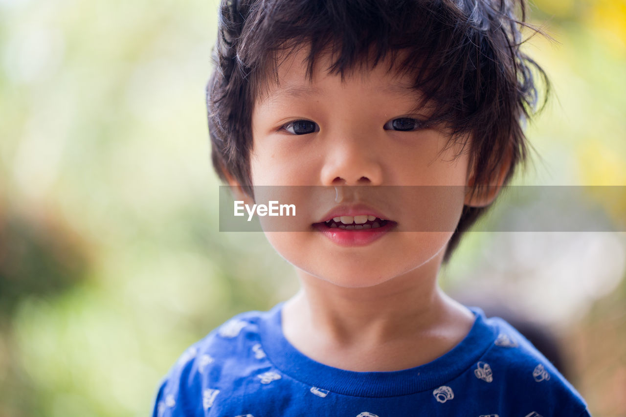 Close-up portrait of cute boy with messy hair