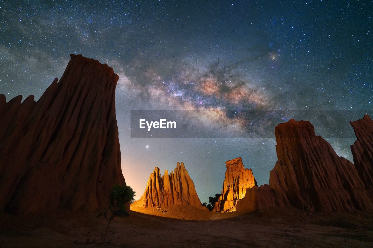 Panoramic view of rock formations with milkyway