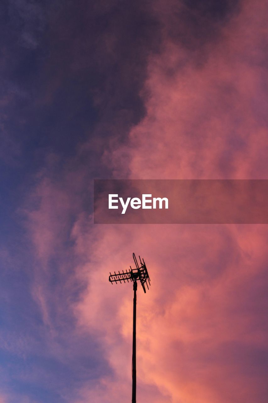 LOW ANGLE VIEW OF SILHOUETTE TELEPHONE POLE AGAINST SKY