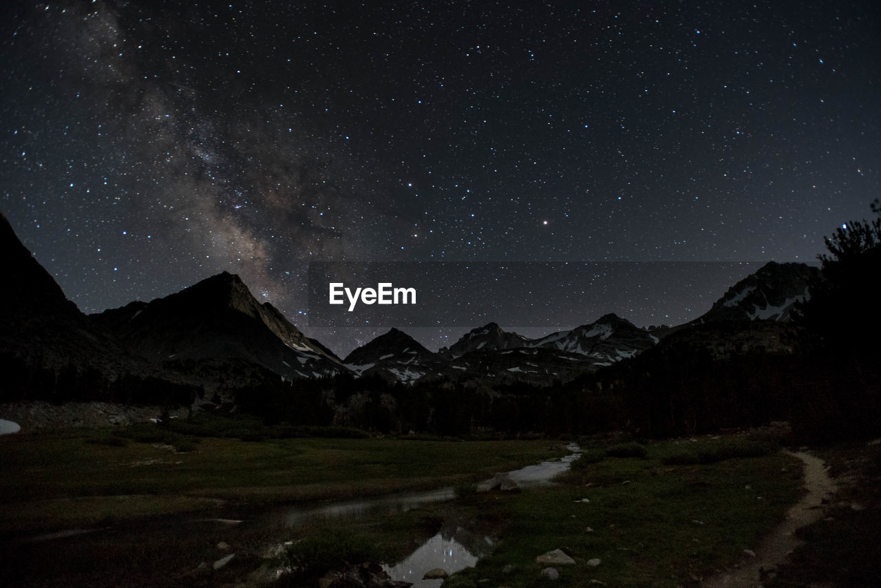 Scenic view of mountains against sky at night