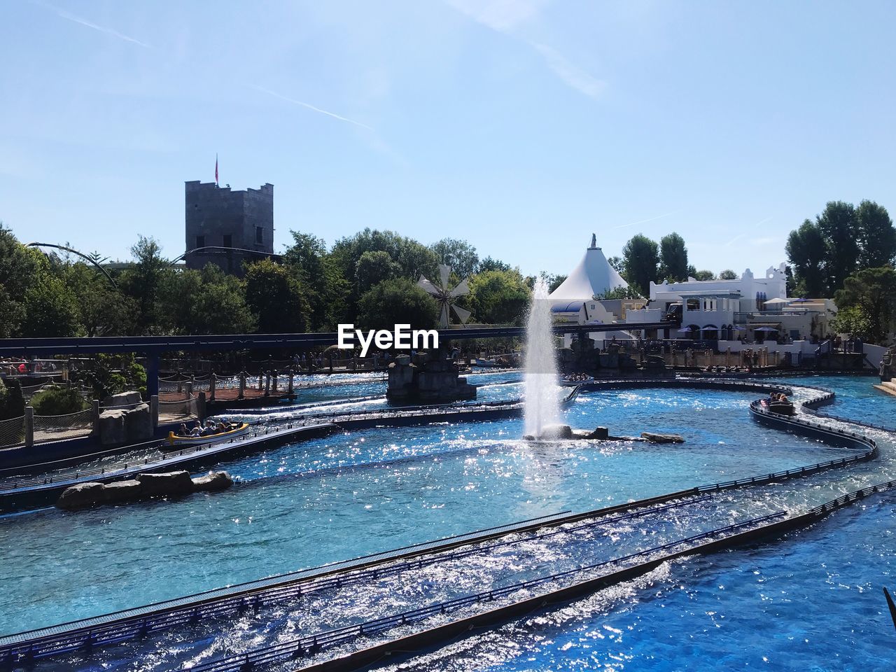 FOUNTAIN IN SWIMMING POOL AGAINST BUILDINGS