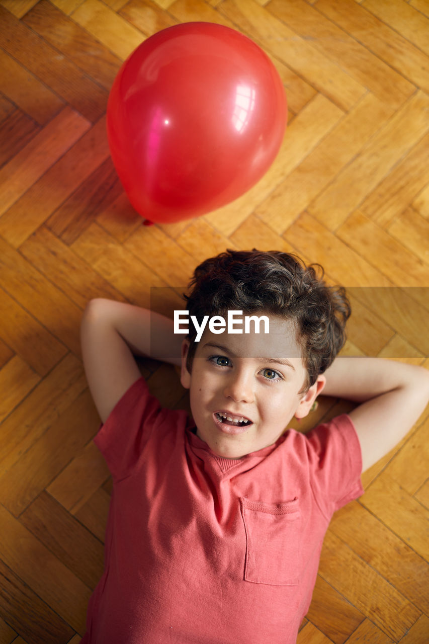 Loving moment of happy boy with his ballon