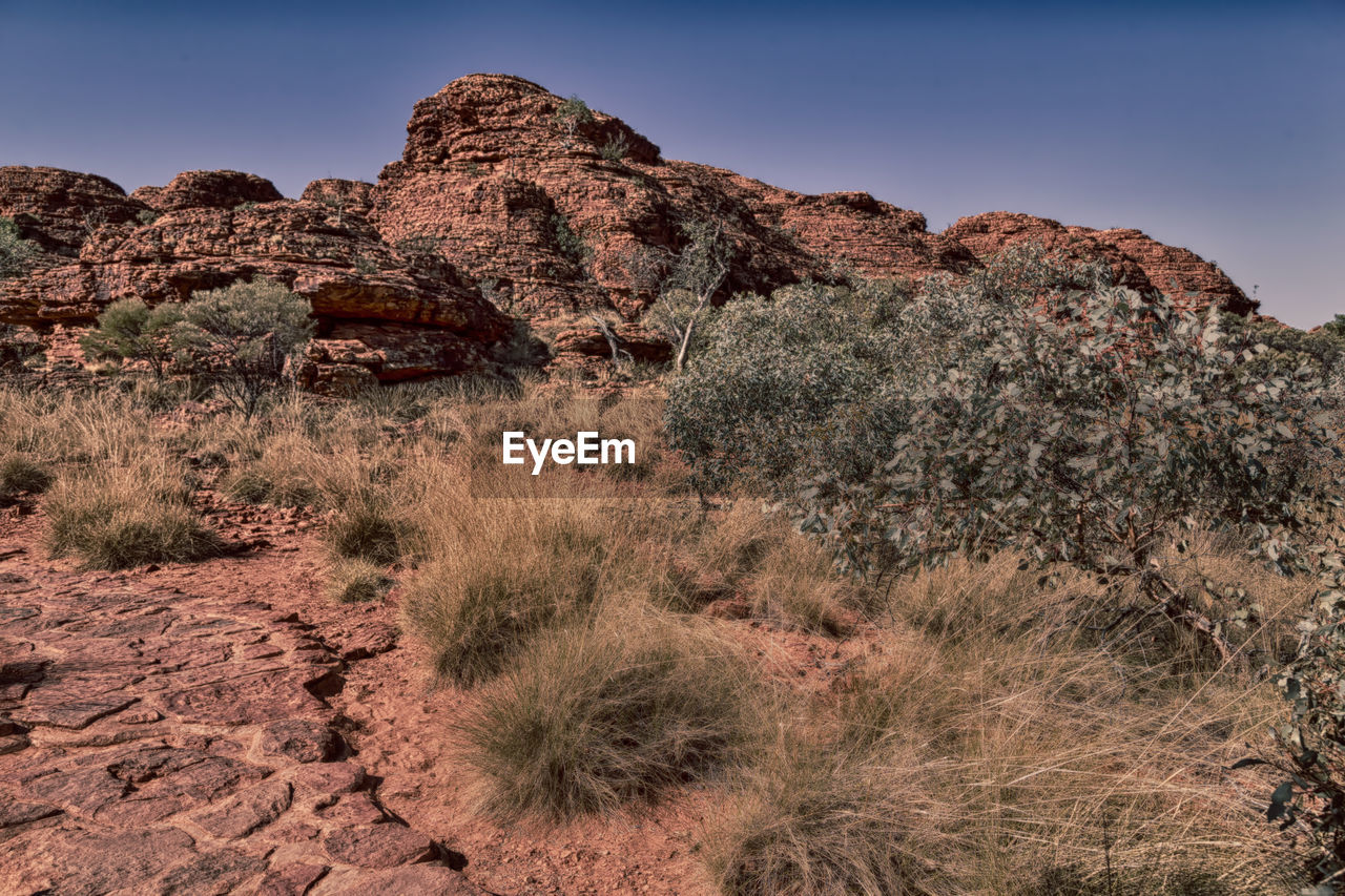 Rock formations on landscape against sky