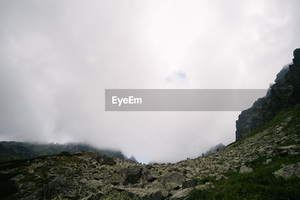 LOW ANGLE VIEW OF PANORAMIC SHOT OF MOUNTAINS AGAINST SKY