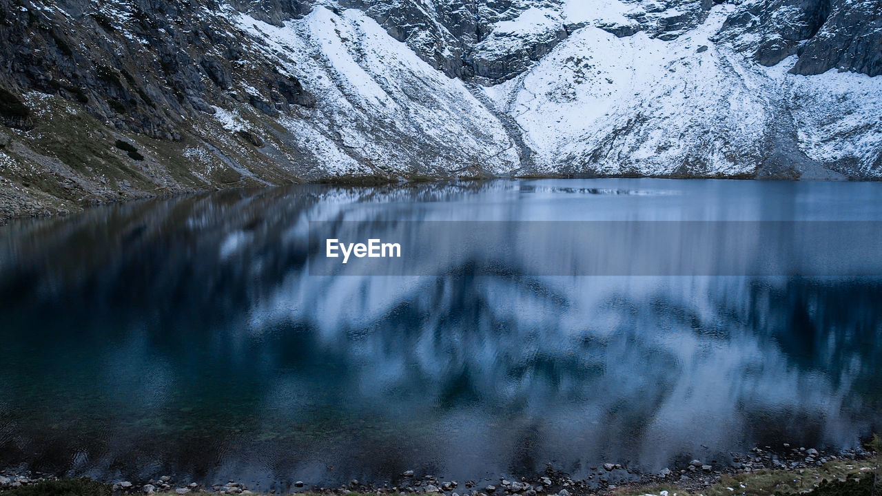 Czarny staw pod rysamy or black pond lake near the morskie oko snowy mountain hut in polish tatry