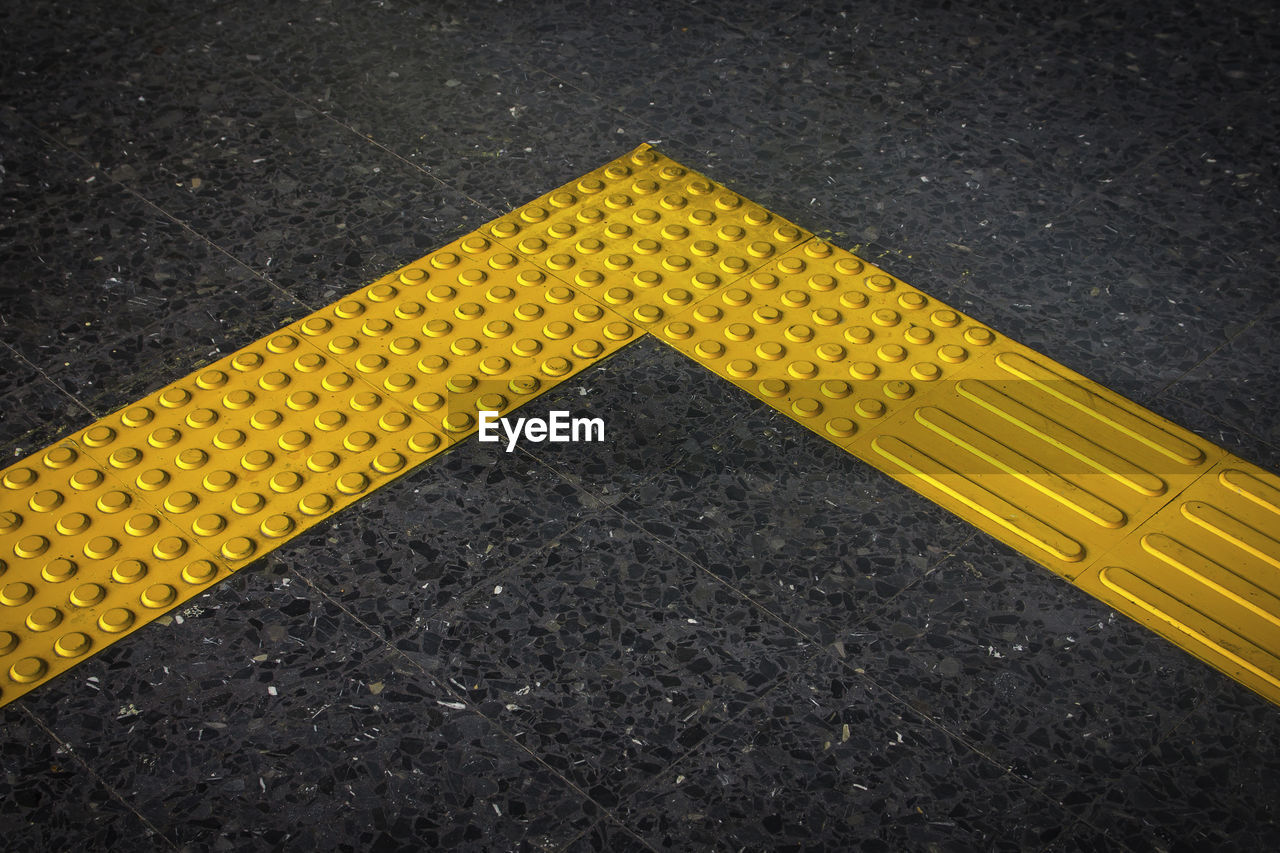 High angle view of yellow sign on road