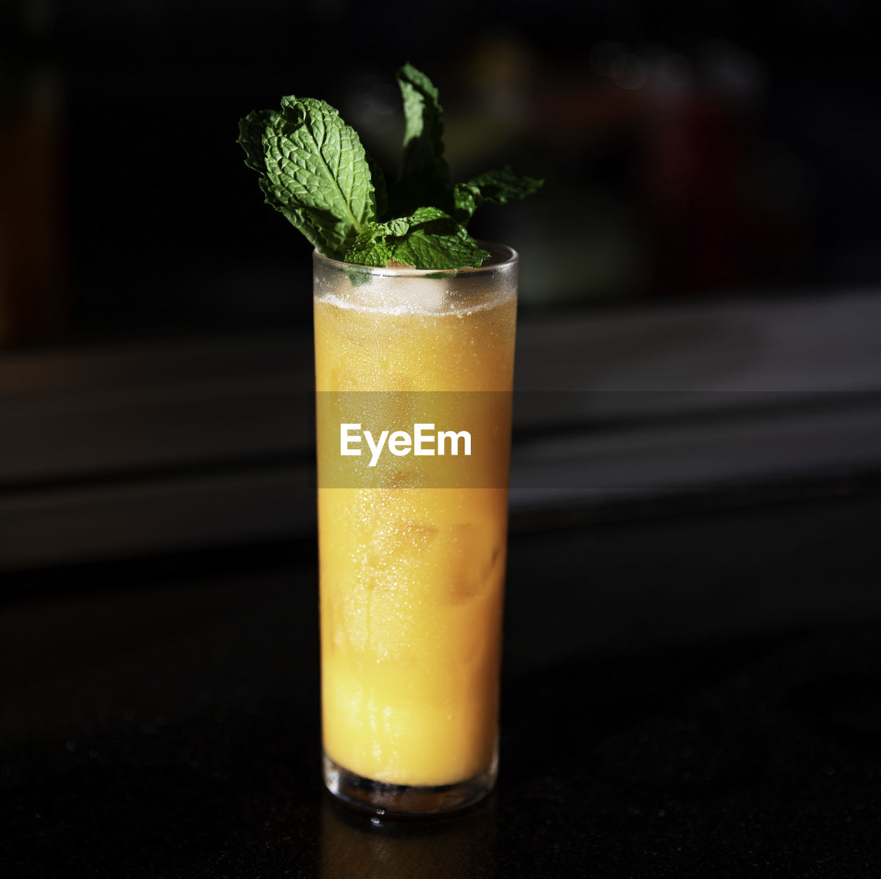 CLOSE-UP OF BEER GLASS ON TABLE