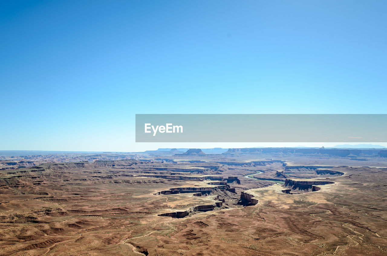 Scenic view of landscape against clear blue sky