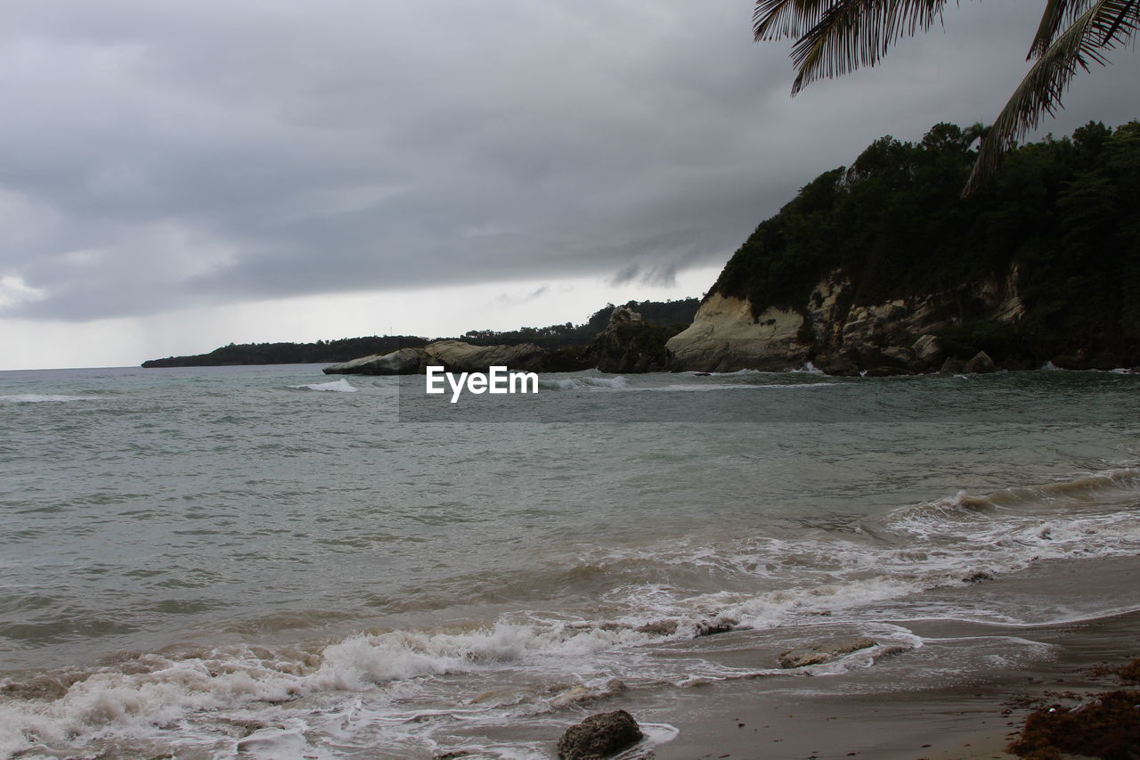 SCENIC VIEW OF SEA WITH MOUNTAINS IN BACKGROUND