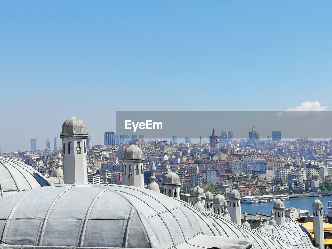 VIEW OF CITY BUILDINGS AGAINST BLUE SKY